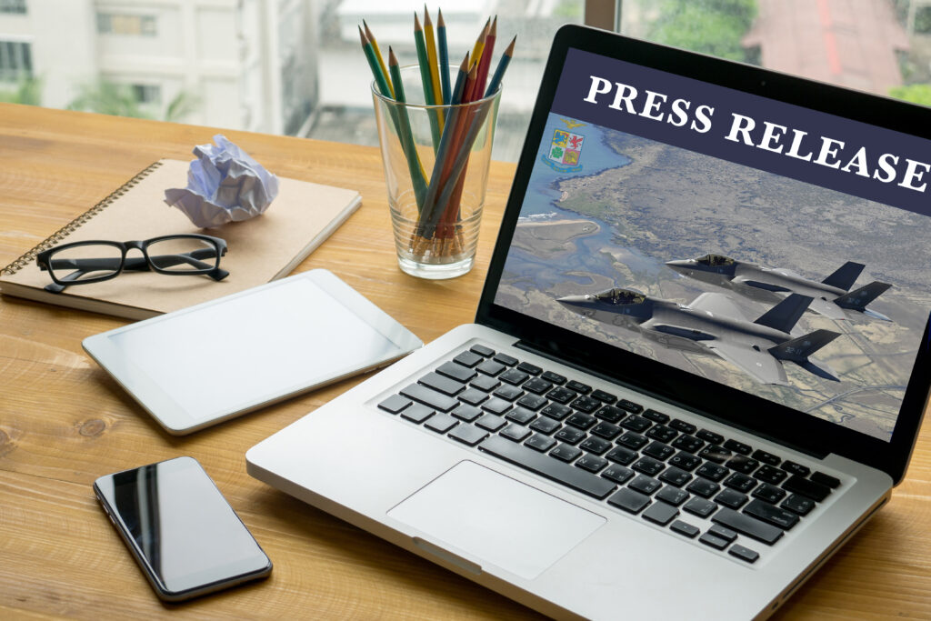 Press Release Laptop on table. Warm tone